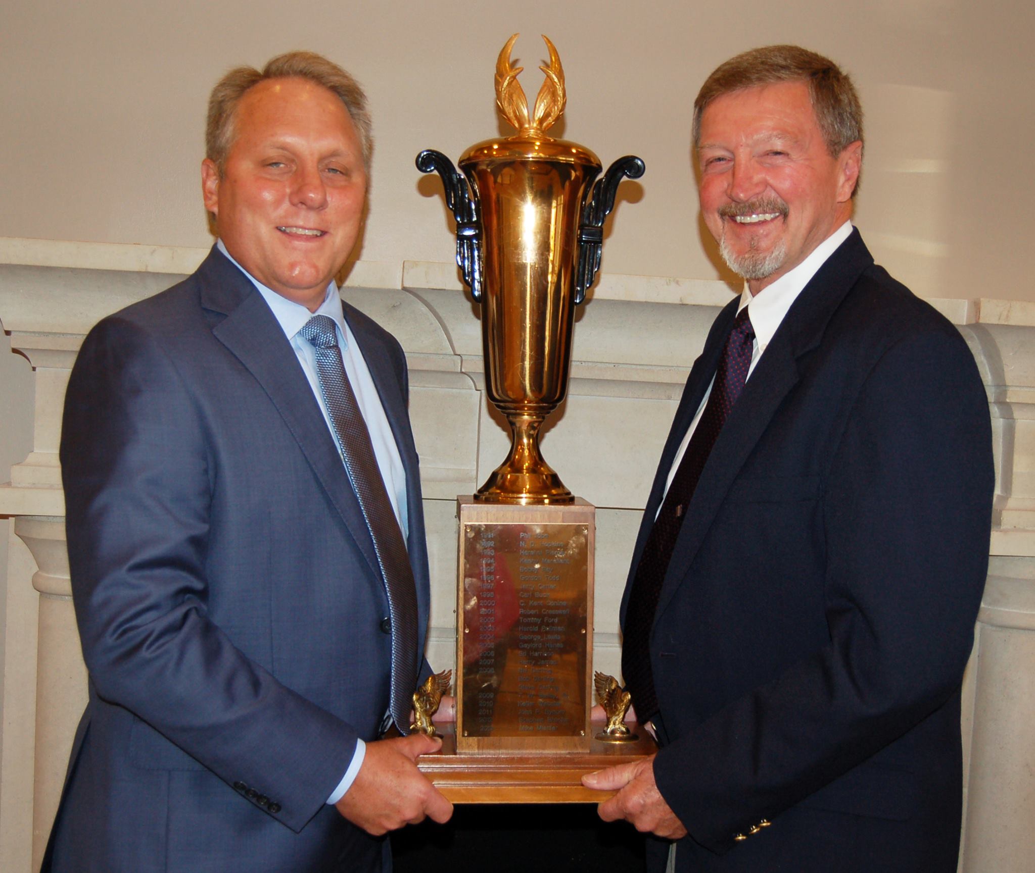 Tim Jackson is presented the Hugh Prather Award from the 2013 recipient Mike Mishler with Mishler Builders